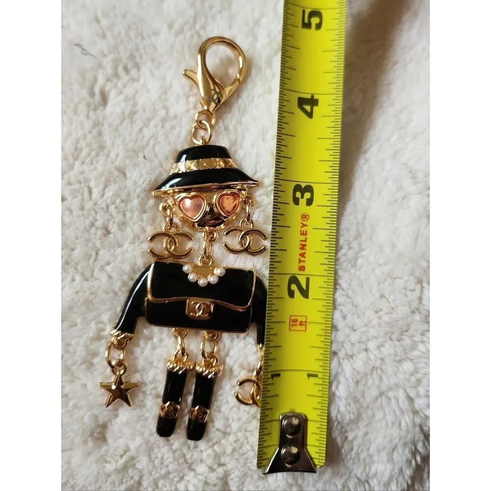 CHANEL Black and Gold Enamel Charm Doll with Pink Heart Sunglasses